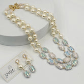 Pearl necklace with gemstone accents and matching earrings on a white background, featuring the brand 'The Anaya Collections'.