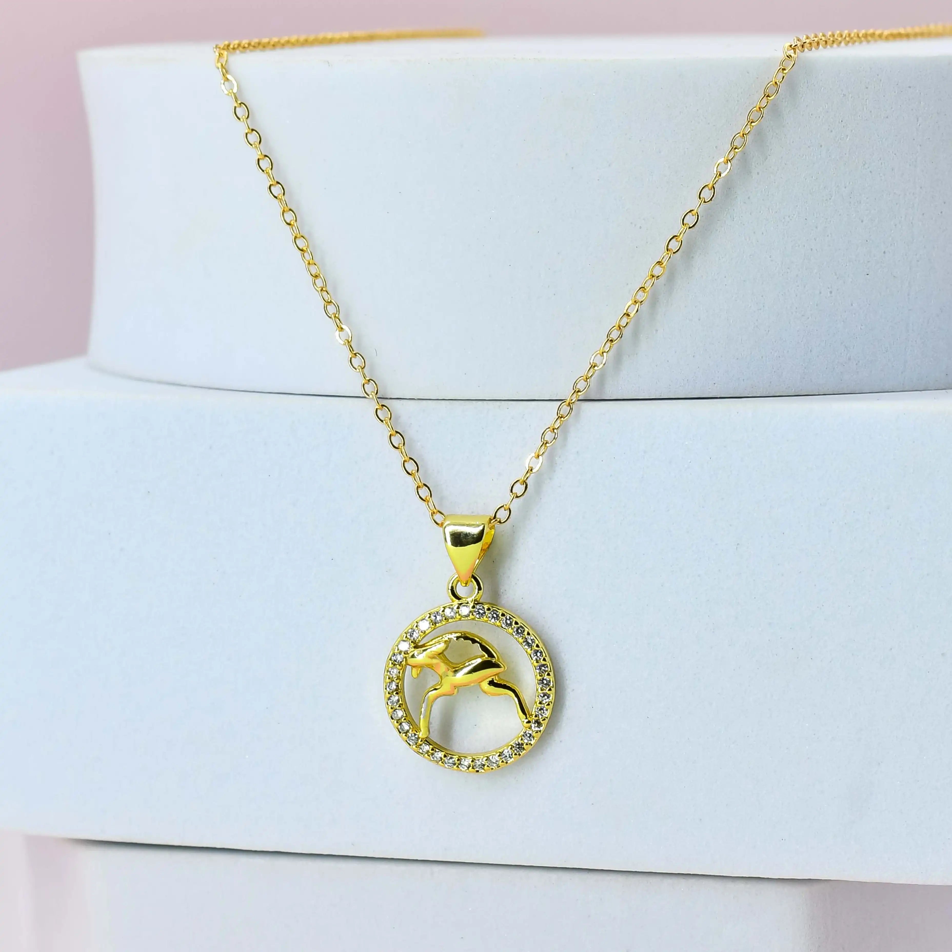 Gold Plated necklace with a Capricorn pendant on a white surface