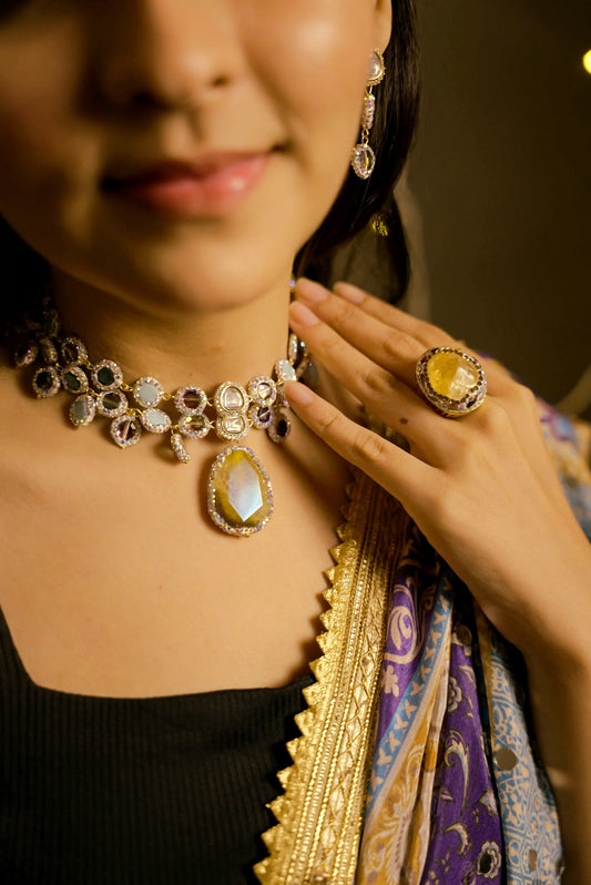 Close-up of a person wearing a decorative necklace and ring with a blurred background