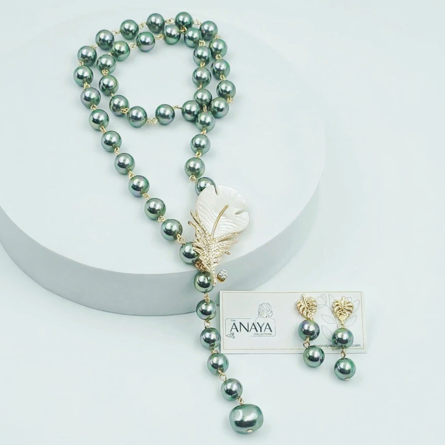 Pearl necklace with feather accessory and matching earrings on a white background, featuring the brand 'Anaya'.