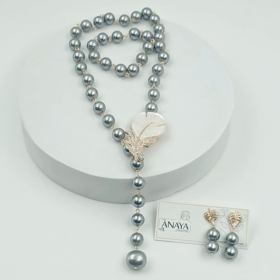 Pearl necklace with a Feather pendant on a white background, featuring The Anaya Collections jewelry.