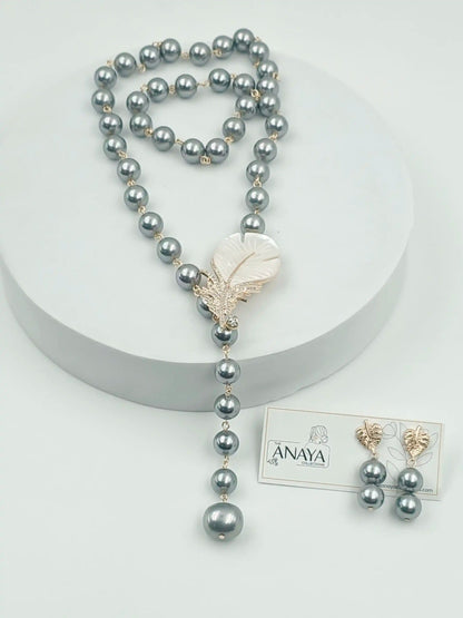 Pearl necklace with a Feather pendant on a white background, featuring The Anaya Collections jewelry.