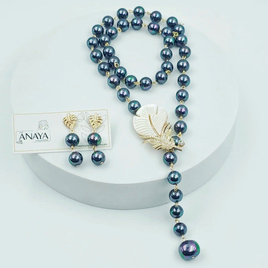 Pearl necklace with a bird pendant and matching earrings on a white background, featuring the Anaya brand.