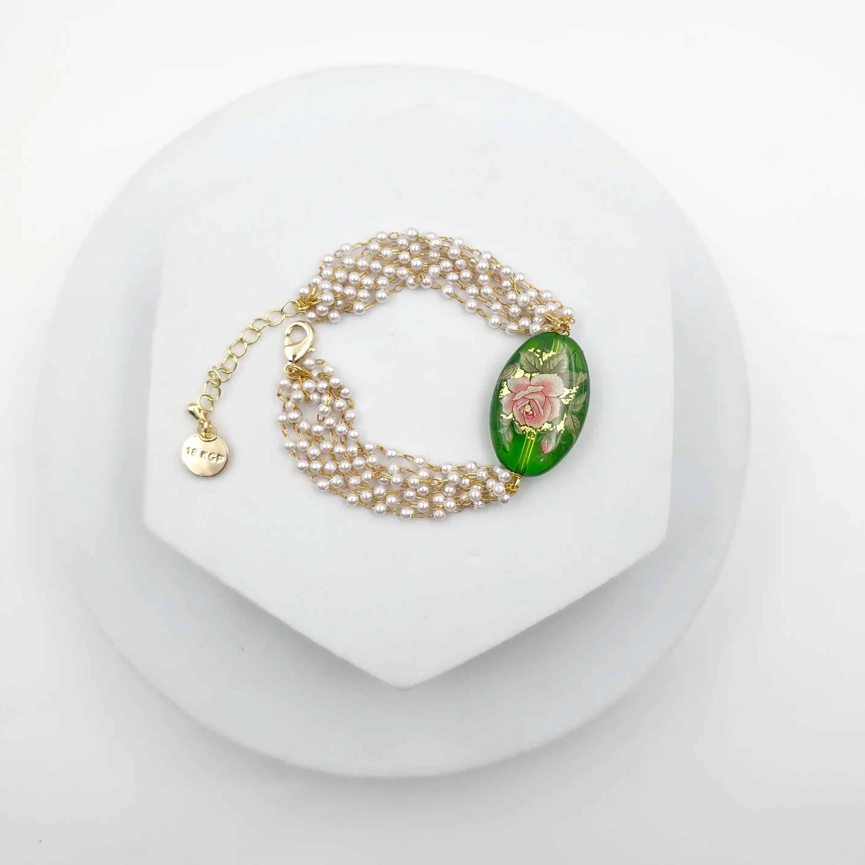 Pearl bracelet with a decorative clasp on a white background