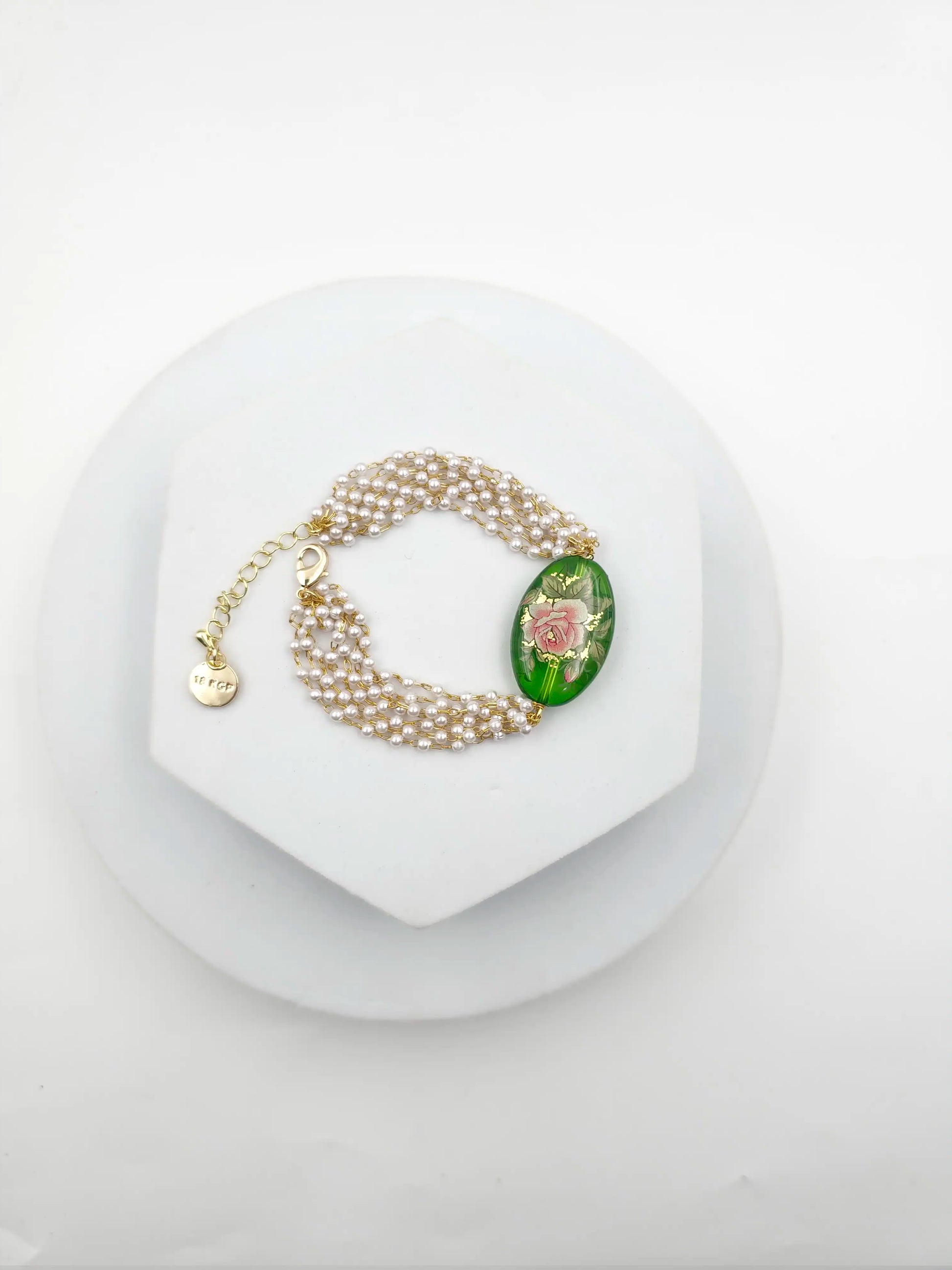 Pearl bracelet with a decorative clasp on a white background