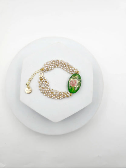 Pearl bracelet with a decorative clasp on a white background