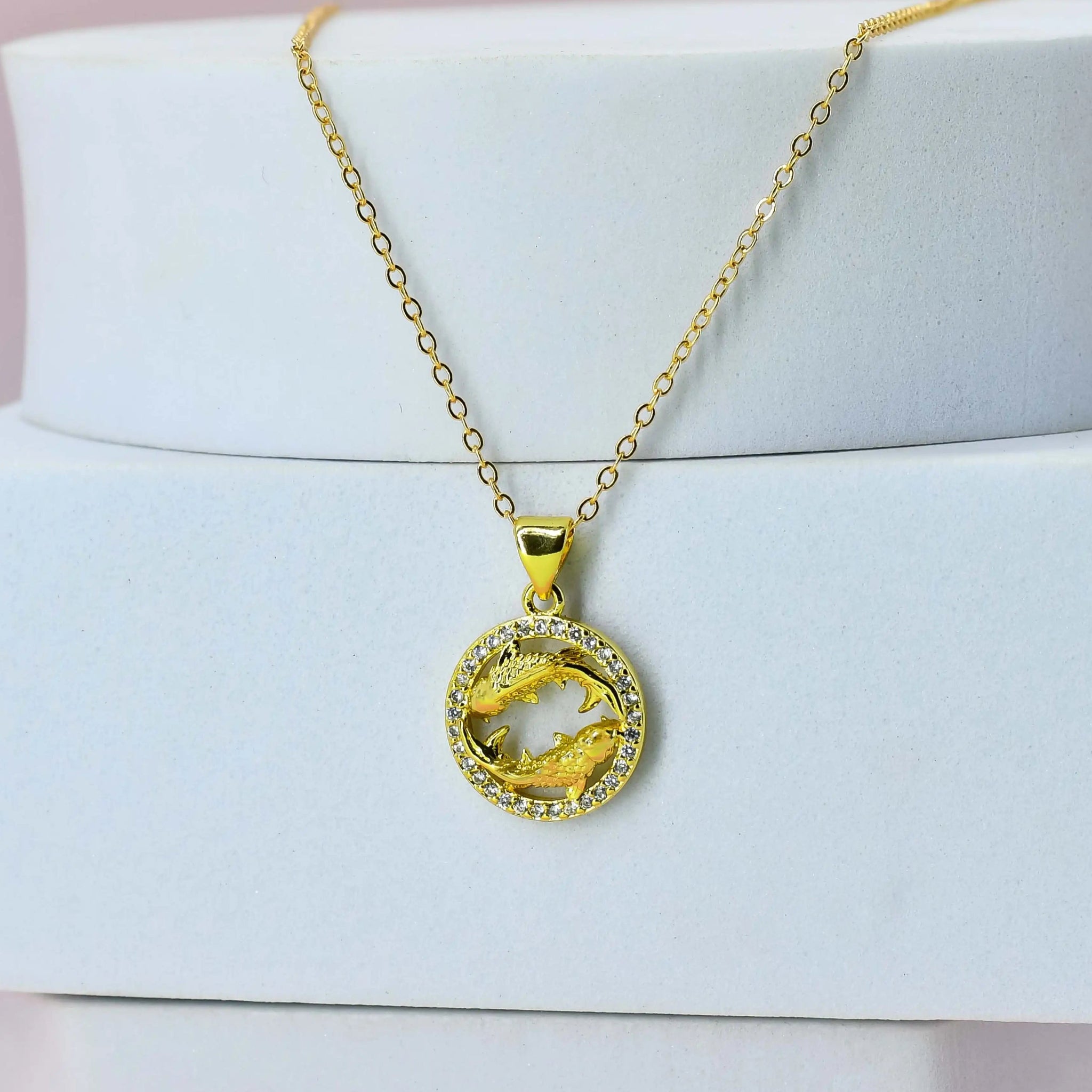 Gold Plated chain with a Pisces pendant on a white stand