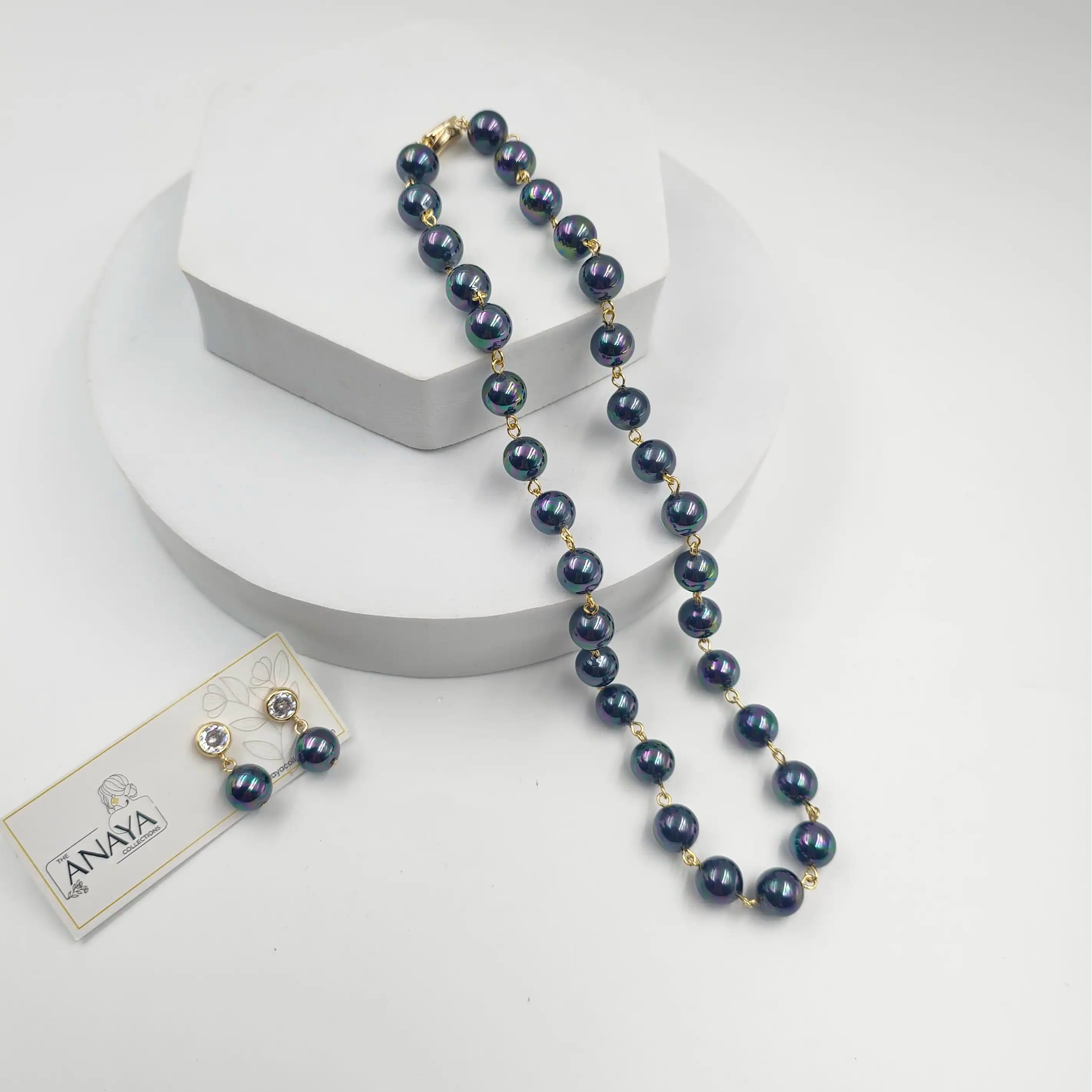 Blue beaded necklace with a tag on a white background