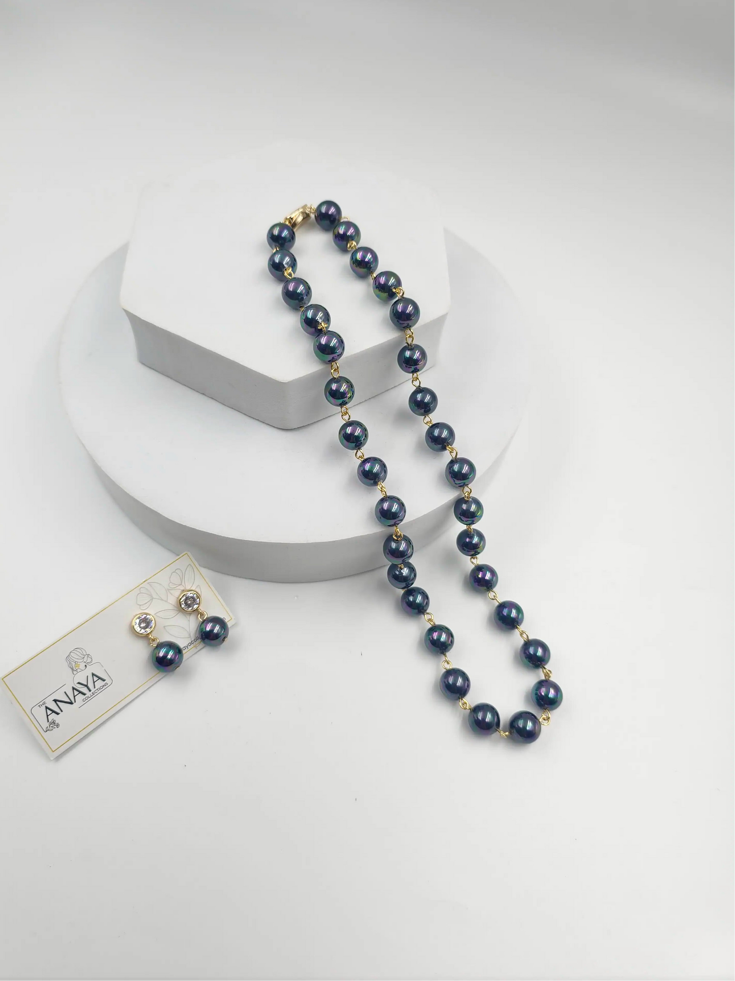 Blue beaded necklace with a tag on a white background