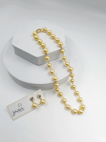 Yellow Pearl necklace with a tag on a white background